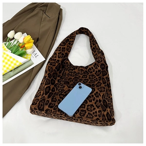 Leopard print tote bag detail showing large capacity with smartphone for scale