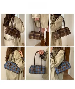 Detail showing checkered plaid handbags in brown and blue with leather handles