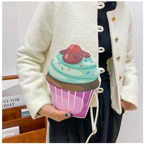 Detail of a cupcake shaped shoulder bag with glitter mint green and brown icing design