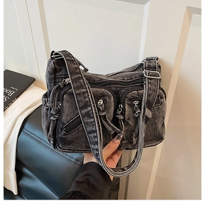 Détail du sac bandoulière en denim noir délavé avec poches multiples zippées