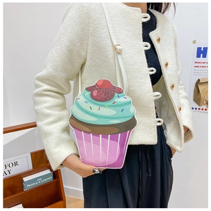 Detail of creative cupcake-shaped crossbody bag with glitter finish and cherry topping