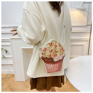 Detail of creative cupcake shaped crossbody bag with heart prints and cream texture