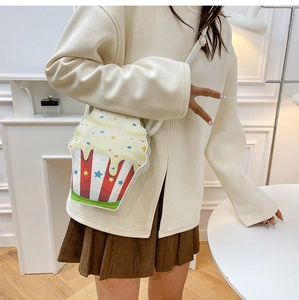 Detail of creative cupcake popcorn crossbody bag with red stripes and star sequins
