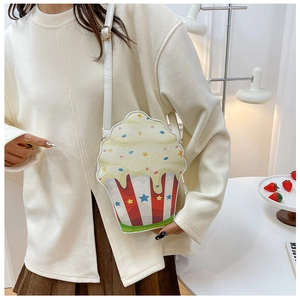 Detail of cute cupcake crossbody bag with red stripes and colorful sequin star accents