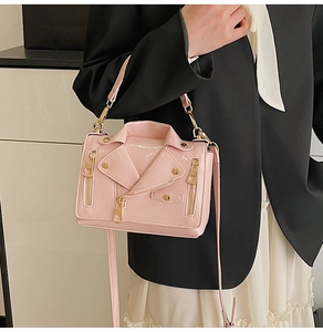 Detail of pink moto jacket shoulder bag with golden rivets and zipper elements