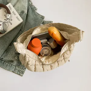 Detailed interior view of beige quilted cloud bag showing spacious storage capacity