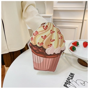Detail of creative cupcake shaped shoulder bag featuring heart patterns and pastel colors