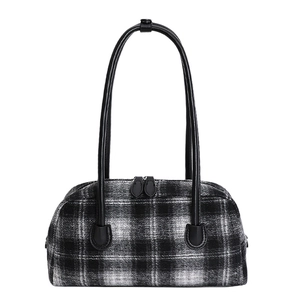 Classic black and white checkered tweed shell handbag with leather handles on white background