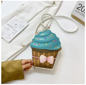 Detail of creative cupcake-shaped crossbody bag with blue cream top and pink glitter bow