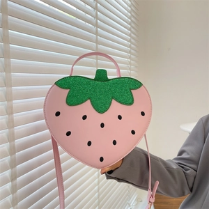 Pink strawberry shaped crossbody bag with green sequin leaves and adjustable shoulder strap