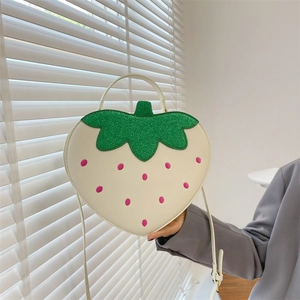 Creative strawberry-shaped crossbody bag with white base and green sequin leaf detail