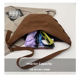 Detail view of large brown canvas crescent bag interior showing ample storage capacity