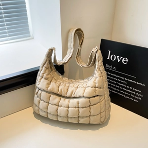 Chic beige quilted cloud bag with plaid puffer texture and wide shoulder strap