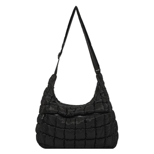 Chic black quilted cloud hobo bag with adjustable shoulder strap on white background