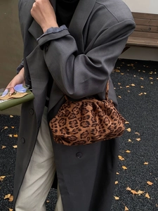 Fashionable leopard print pouch bag featuring a pleated design and stylish textile texture