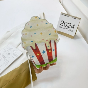 Creative cupcake shaped crossbody bag with glitter top and striped pattern detail