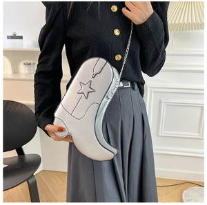 Vue détaillée d'un sac bandoulière argenté en forme de botte de cowboy avec motif étoile