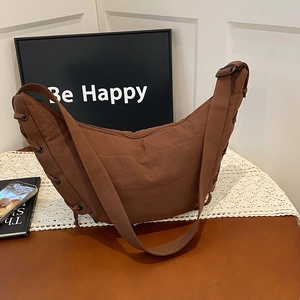 Large dark brown nylon dumpling bag with adjustable wide strap and drawstring detail