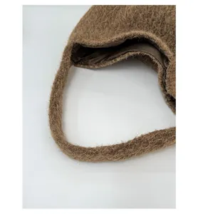 Detail of wide shoulder strap and soft brown plush texture on large winter tote bag