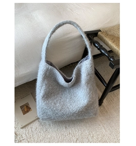 Detail of the soft grey plush hobo bag texture and wide shoulder strap design