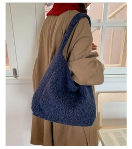 Deep blue faux fur tote bag showing the soft texture and large capacity on model