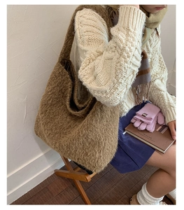 Detail of brown plush tote bag showing soft sherpa texture and wide shoulder strap