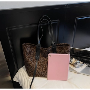 Leopard print tote bag size comparison with tablet showing spacious interior and handles