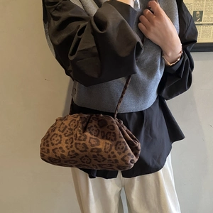 Minimalist leopard print cloud shoulder bag for women styled with vintage aesthetic