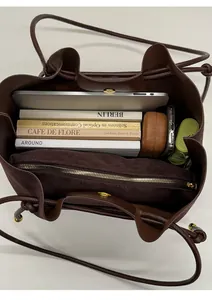 Internal view of brown tote bag showing large capacity for books and inner zipper pouch