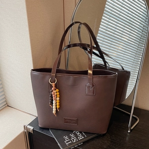 Vintage dark brown large tote bag with top handles and decorative wooden bead charm