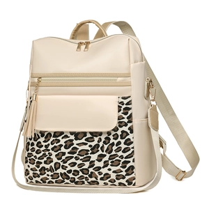 Minimalist beige leather backpack with leopard print panels and decorative tassel