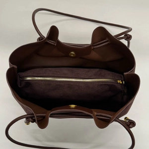 Vertical view of the spacious interior with zippered compartment and magnetic closure