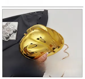 Polished gold acrylic evening clutch bag with elegant chain strap and mirror finish detail
