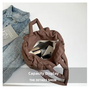 Macro view of brown quilted tote bag showing high capacity for laptop and daily essentials