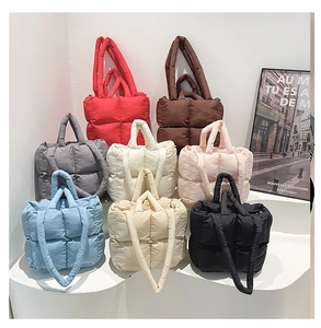 Detailed color selection of quilted tote bags featuring puffer padding and dual handles