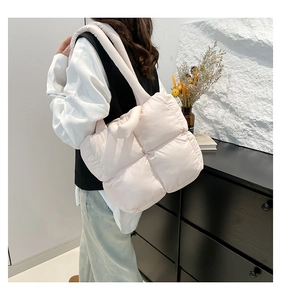 Quilted tote bag in pale pink with padded handles and puffy nylon texture finish