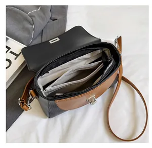 Detail of the multi-compartment interior with a zipper pocket in a chic crossbody bag