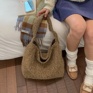 Brown fluffy faux fur tote bag for women shown in a cozy winter lifestyle setting