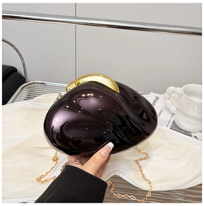 Detail of glossy purple acrylic pebble clutch bag with gold chain and metal clasp
