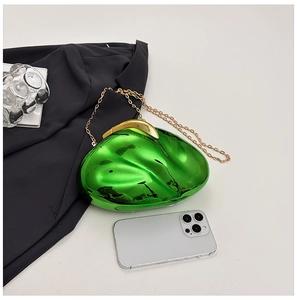 Close-up of vibrant green acrylic clutch with gold chain strap and metal clasp detail