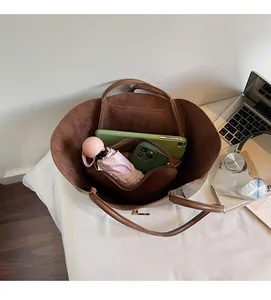 Top view of large brown tote bag interior with matching inner pouch and office essentials