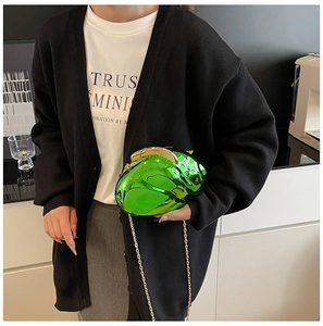 Close-up of neon green mirrored clutch bag with gold chain and pebble-shaped design
