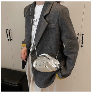 Silver mirror acrylic rabbit-shaped handbag with long metallic chain on grey blazer