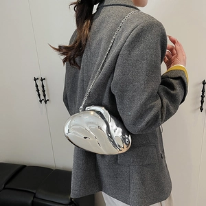 Detail of silver metallic crossbody bag with mirror finish and slim chain strap