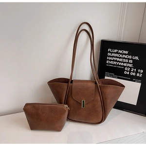 Detail of vintage brown tote set with a textured PU leather bag and matching pouch
