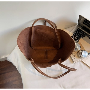 Interior view of large brown suede tote bag with inner pocket and spacious compartment
