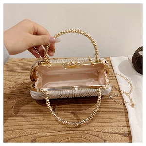 Detail view of silver sequin evening bag with pearl handle and soft pink satin lining