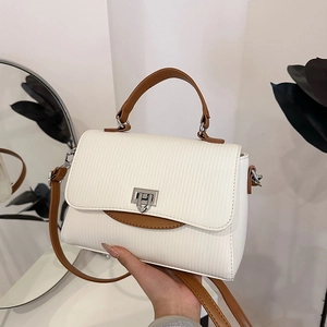 Elegant white textured leather handbag with brown handles and a stylish silver turn-lock