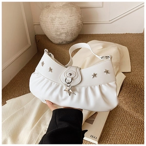 Detail of white leather hobo bag featuring pleated texture and silver star charms