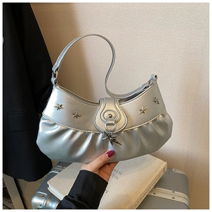 Close-up of silver pleated leather bag with metallic stars and star pendant detail